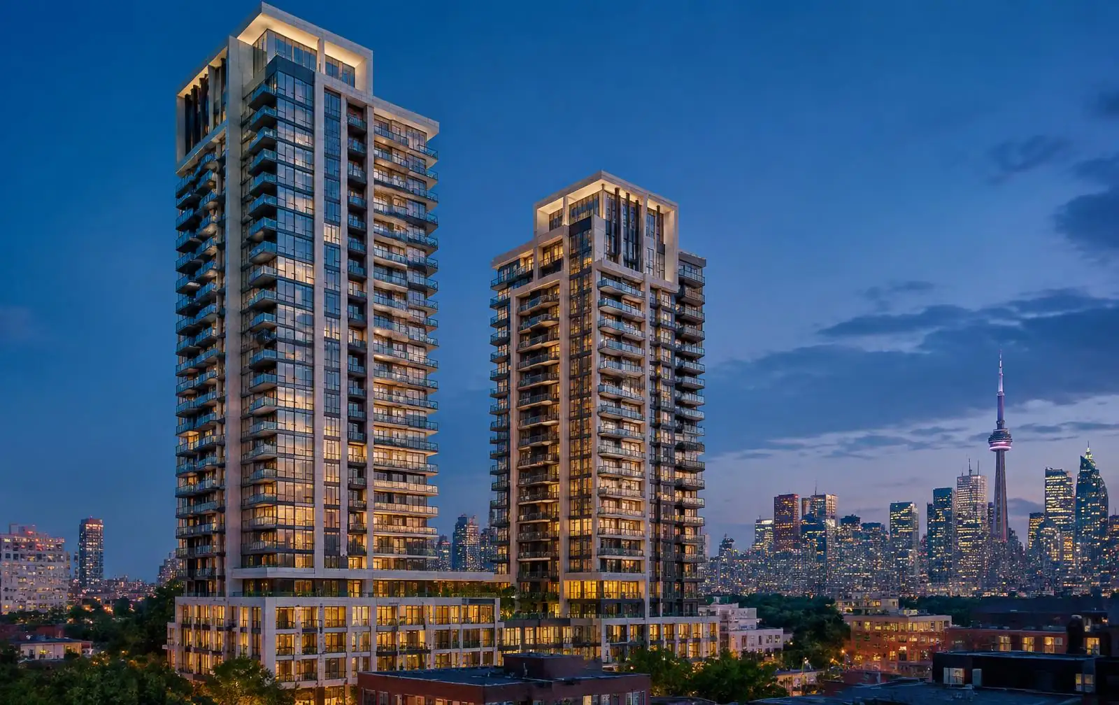 Modern condominium towers overlooking the Toronto skyline at blue hour